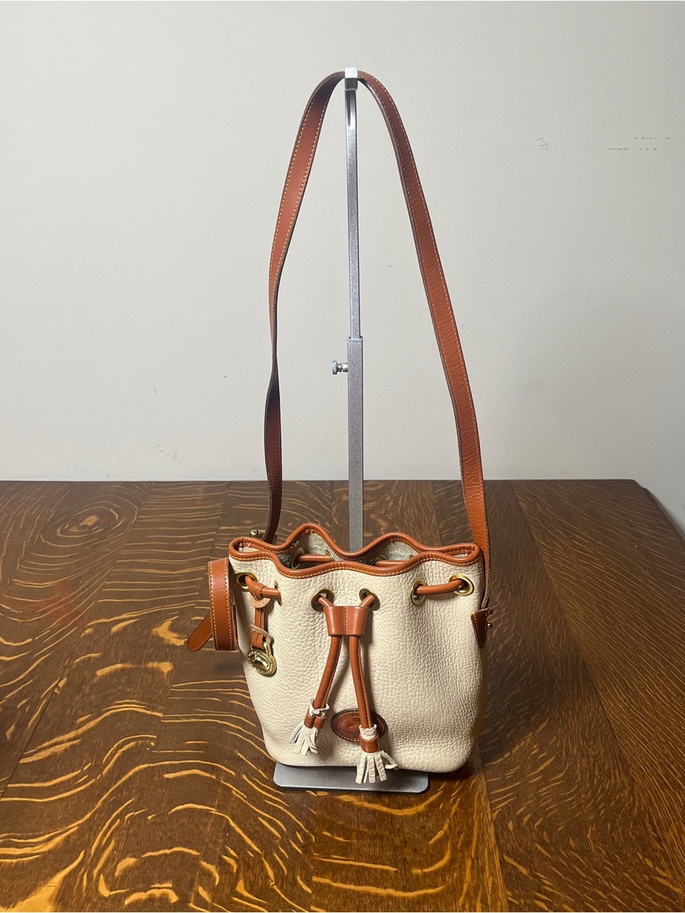 Dooney & Bourke Cream and Tan Leather-Trim Drawstring Bucket Shoulder Bag.